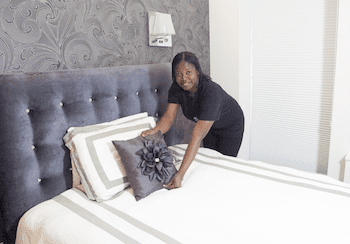 cleaning maid finishing cleaning the bedroom