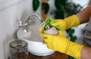 maid cleaning bathroom amenities 